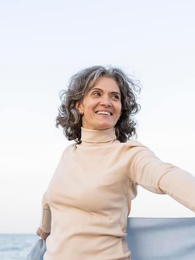 7 Science-Backed Reasons to Choose GLP-1 from AgelessRx Older woman enjoying her time on the beach