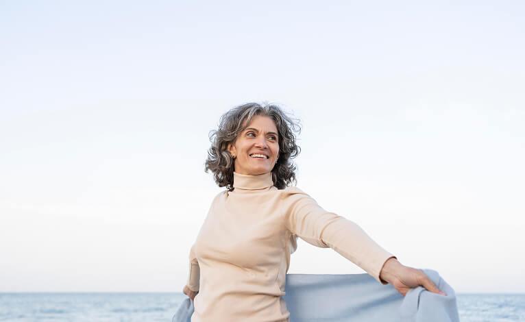 7 Science-Backed Reasons to Choose GLP-1 from AgelessRx Older woman enjoying her time on the beach